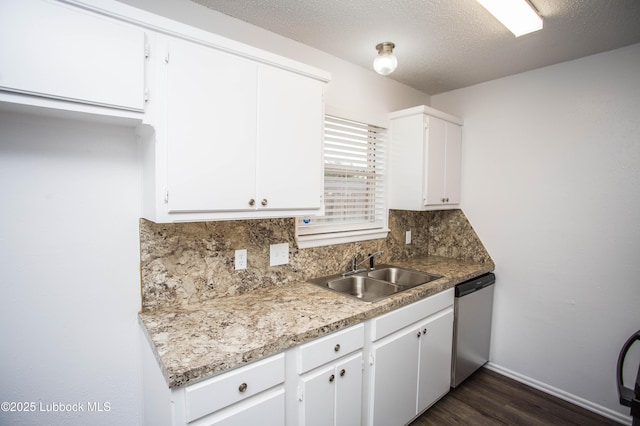 4638 Fordham St, Lubbock, TX 79416 - kitchen featuring stainless steel dishwasher, decorative backsplash, dark wood-style floors, white cabinets, and a textured ceiling