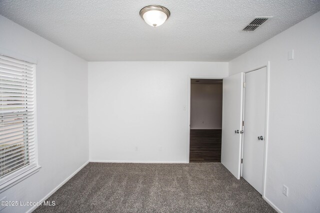 4638 Fordham St, Lubbock, TX 79416 - carpeted empty room featuring a textured ceiling and healthy amount of natural light
