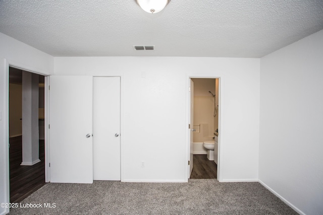 4638 Fordham St, Lubbock, TX 79416 - unfurnished bedroom with carpet floors, a closet, a textured ceiling, and connected bathroom