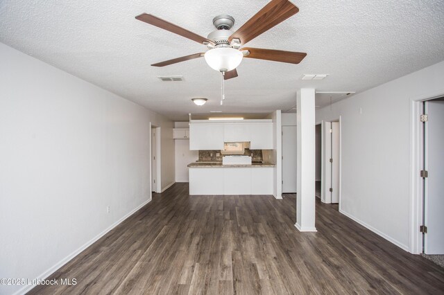 4638 Fordham St, Lubbock, TX 79416 - unfurnished living room with a ceiling fan, dark wood-type flooring, and a textured ceiling
