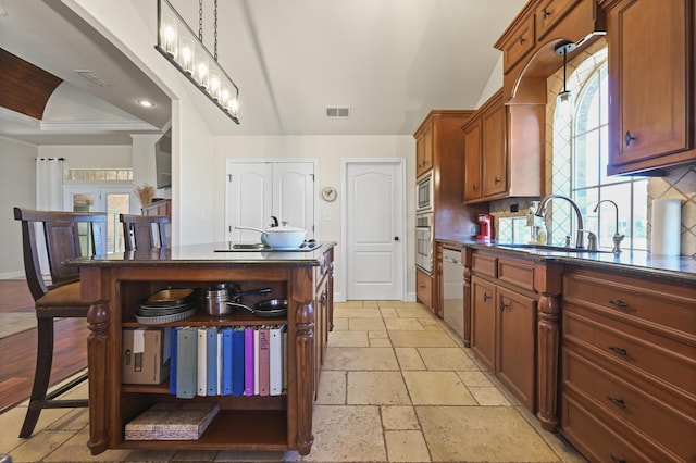 kitchen featuring open shelves, dark countertops, stone tile floors, and a sink