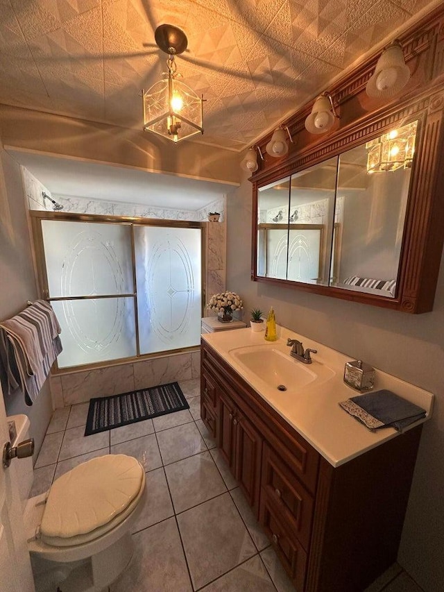 bathroom with vanity, toilet, and tile patterned flooring