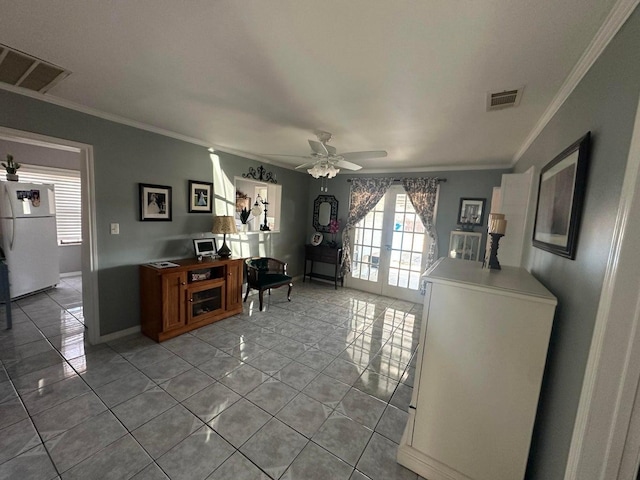 interior space with ornamental molding and ceiling fan