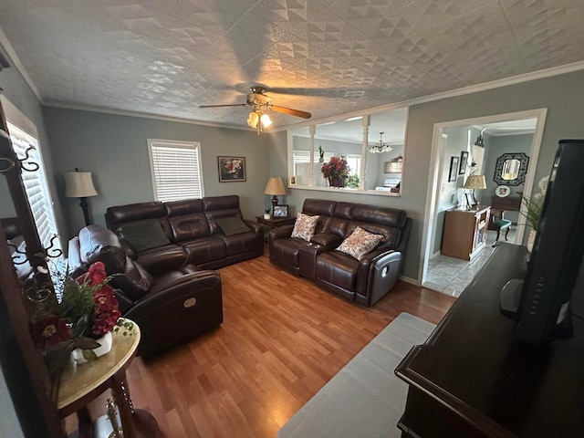 living room featuring ceiling fan, ornamental molding, and wood-type flooring