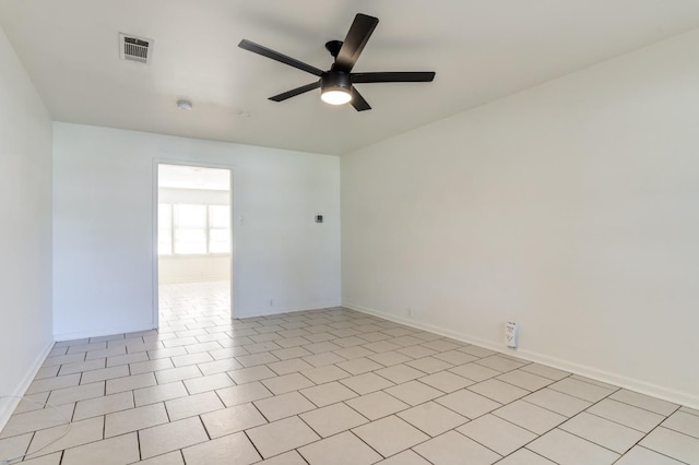 spare room featuring light tile patterned flooring and ceiling fan