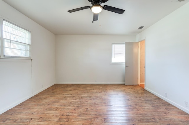 empty room featuring ceiling fan and light wood-type flooring