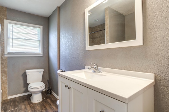 bathroom featuring vanity, wood-type flooring, a shower, and toilet