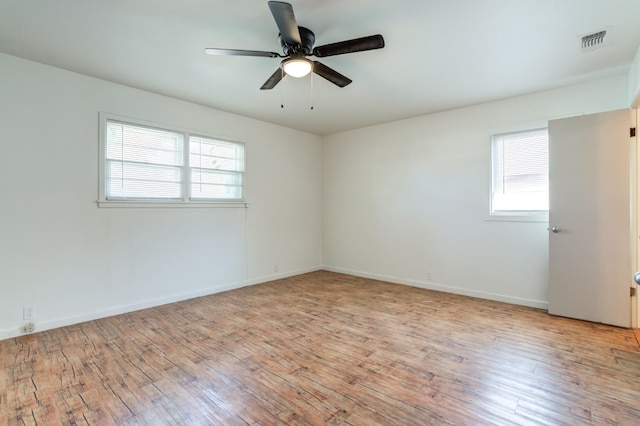 empty room featuring ceiling fan and light hardwood / wood-style flooring