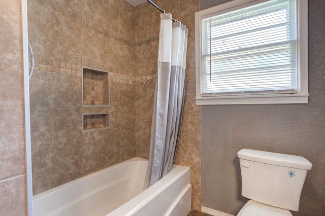 bathroom featuring toilet and shower / bathtub combination with curtain