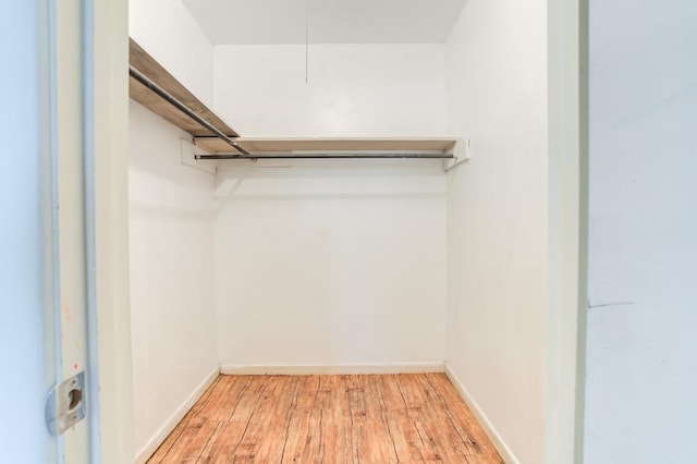 spacious closet featuring light hardwood / wood-style floors