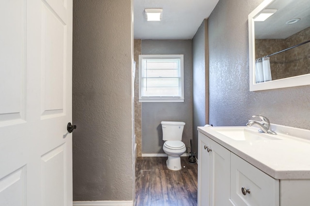 bathroom featuring vanity, wood-type flooring, toilet, and a shower with shower curtain