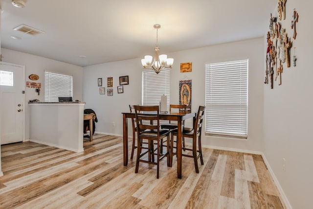 dining room featuring a chandelier and light wood-type flooring