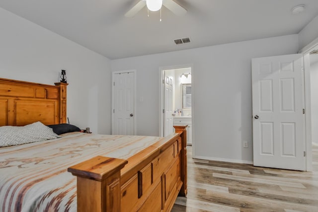 bedroom featuring connected bathroom, ceiling fan, and light hardwood / wood-style flooring