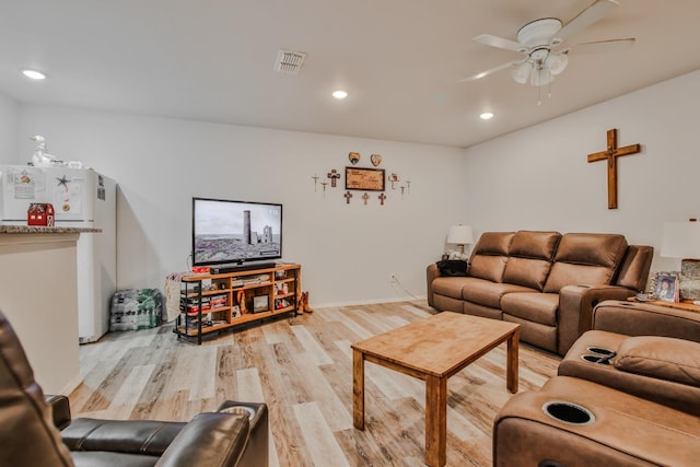 living room featuring light hardwood / wood-style floors and ceiling fan