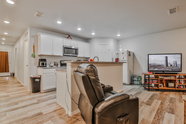 living room with light hardwood / wood-style flooring