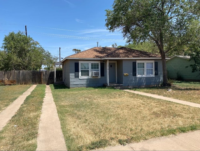 view of front facade with a front yard and cooling unit