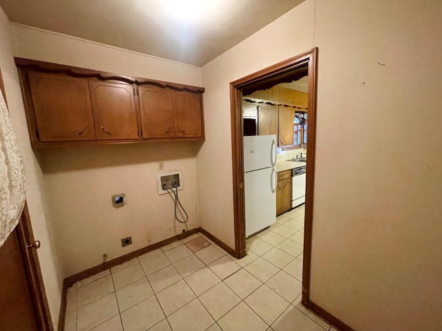 laundry area featuring cabinets, electric dryer hookup, washer hookup, and light tile patterned floors