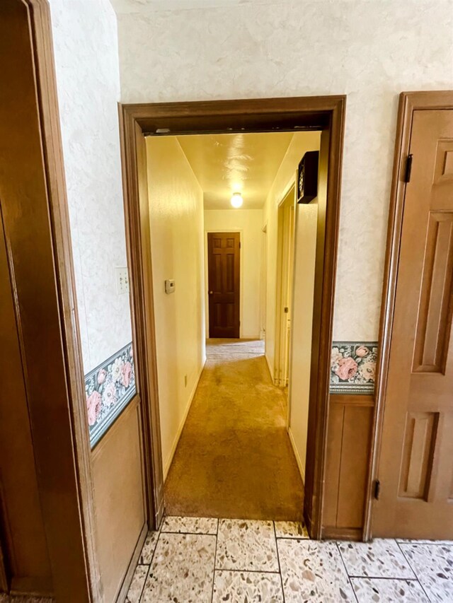 hall featuring light tile patterned flooring