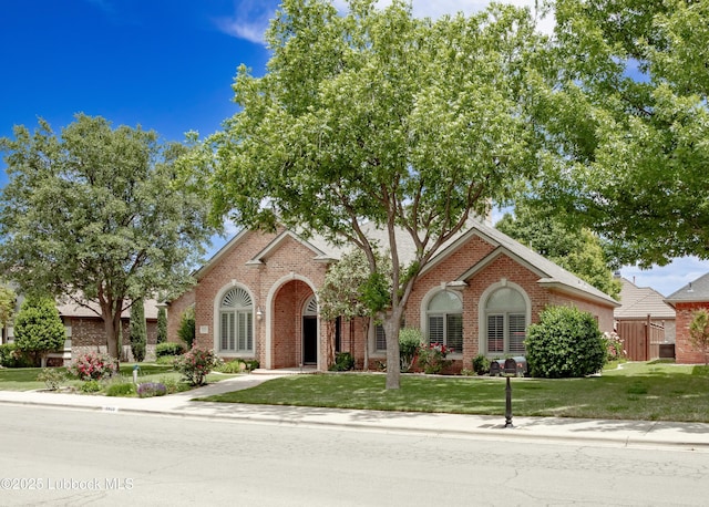9805 Savannah Ave, Lubbock, TX 79424 - view of front facade with brick siding, a front lawn, and cooling unit