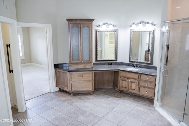 9805 Savannah Ave, Lubbock, TX 79424 - full bathroom featuring vanity, a stall shower, and tile patterned flooring