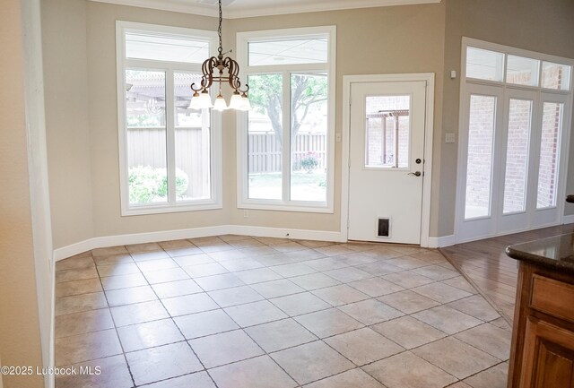 9805 Savannah Ave, Lubbock, TX 79424 - foyer featuring light tile patterned flooring, a chandelier, and baseboards