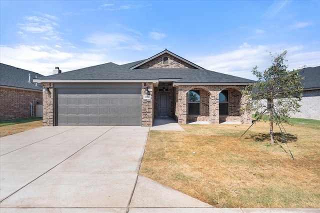 view of front of home with a garage and a front lawn