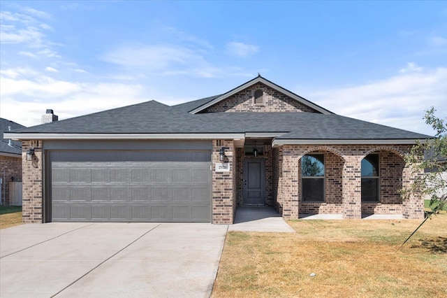 view of front of home featuring a garage and a front lawn