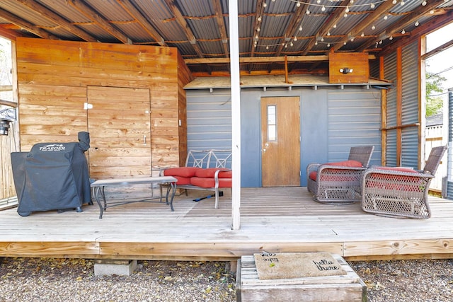 wooden deck featuring a grill