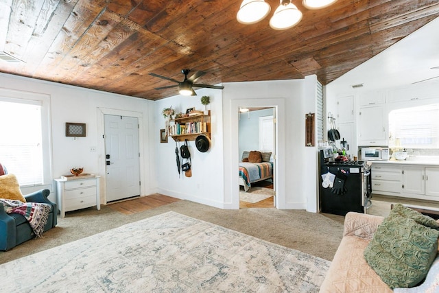 carpeted foyer entrance featuring wooden ceiling and ceiling fan