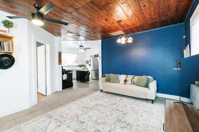 carpeted living room with ceiling fan with notable chandelier and wooden ceiling