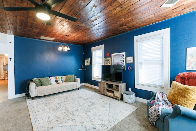 living room featuring wood ceiling, carpet flooring, and ceiling fan with notable chandelier