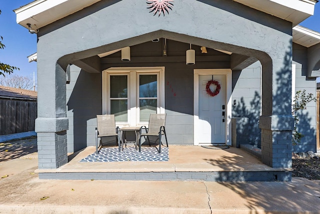 view of exterior entry featuring a patio area