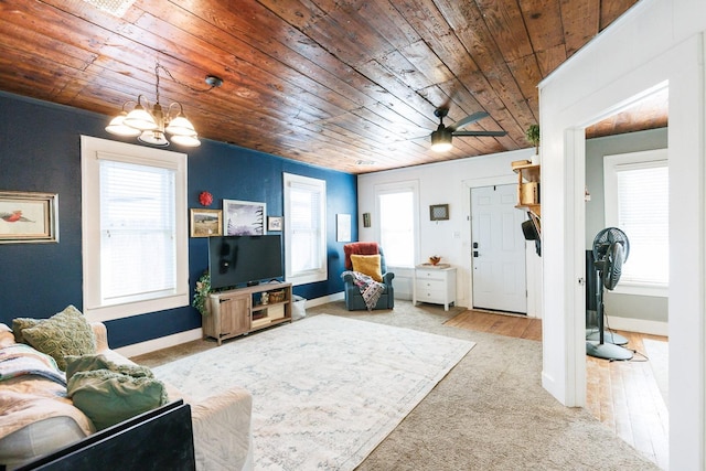 carpeted living room with a chandelier and wooden ceiling