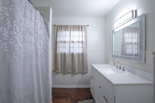 5426 9th St, Lubbock, TX 79416 - bathroom featuring vanity, wood finished floors, and a shower with curtain