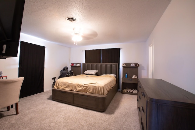 5426 9th St, Lubbock, TX 79416 - bedroom with light colored carpet, a textured ceiling, and a ceiling fan