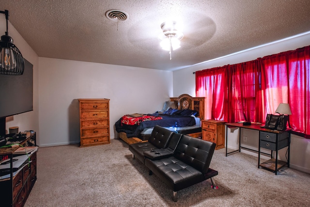 5426 9th St, Lubbock, TX 79416 - carpeted bedroom with a textured ceiling, a ceiling fan, and a baseboard heating unit