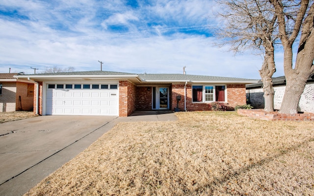 5426 9th St, Lubbock, TX 79416 - ranch-style home with driveway, an attached garage, brick siding, and a front lawn