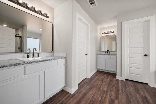 bathroom with hardwood / wood-style flooring and vanity