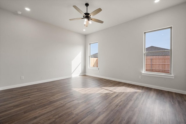 empty room featuring ceiling fan and dark hardwood / wood-style flooring