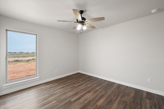 spare room with ceiling fan and dark hardwood / wood-style flooring