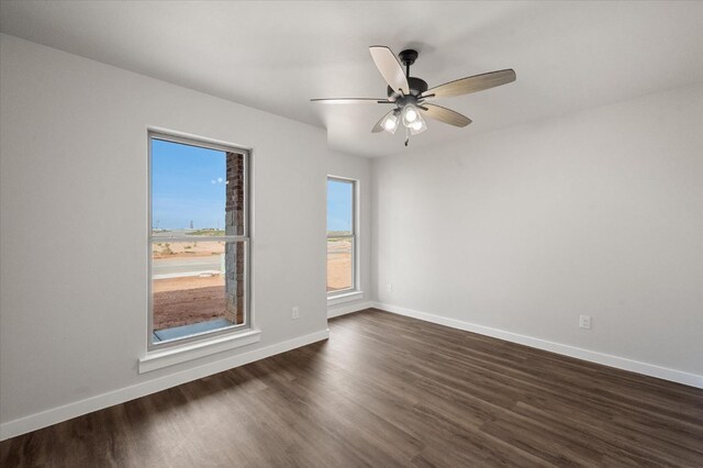 unfurnished room featuring dark hardwood / wood-style floors and ceiling fan