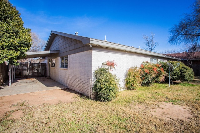 view of side of property with a carport