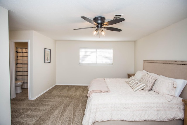 carpeted bedroom with ceiling fan and ensuite bath