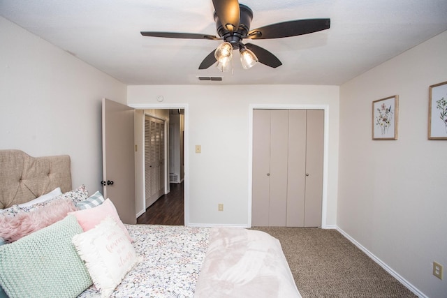 bedroom with ceiling fan, dark carpet, and a closet