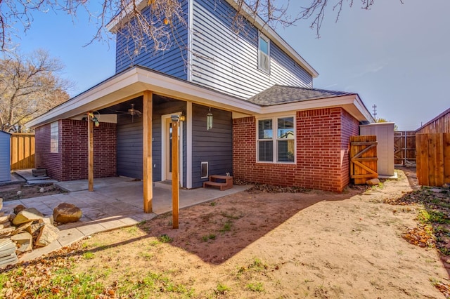 rear view of property with a patio and ceiling fan