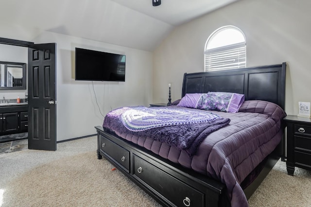 carpeted bedroom with lofted ceiling