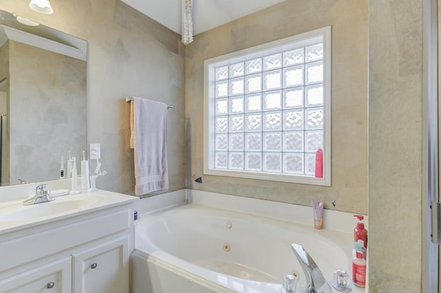 bathroom featuring vanity and a washtub