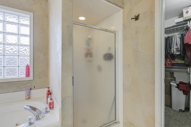 bathroom featuring shower with separate bathtub