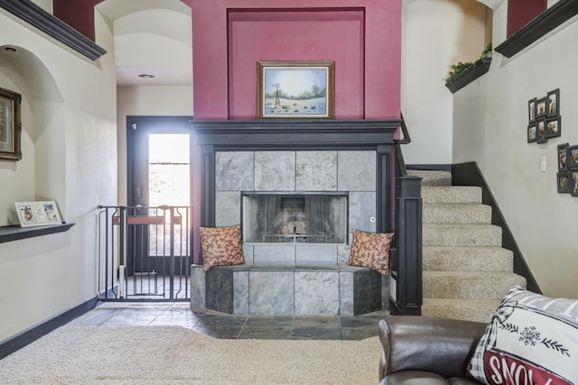 living room featuring a tiled fireplace