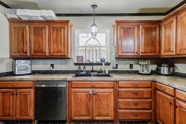 kitchen with dishwasher, sink, pendant lighting, and backsplash